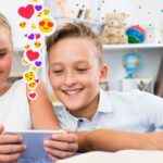 one tween girl and boy watching their smartphones with emoji icons near the phones