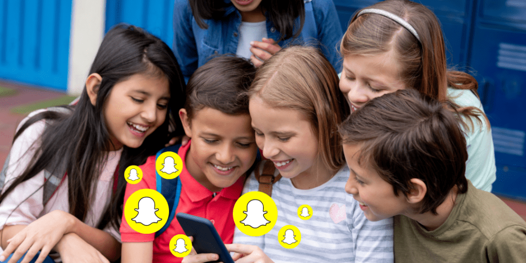 5 kids watching a phone with snapchat icons near the phone