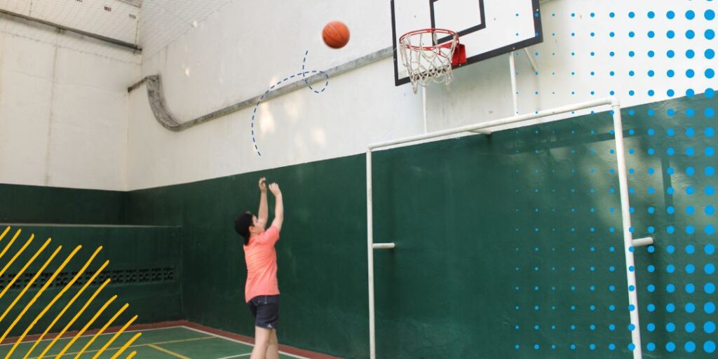 boy playing basketball alone on a court