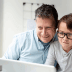 father and son using ChatGPT on laptop together