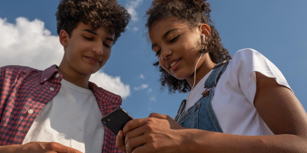 Two teens looking at a phone