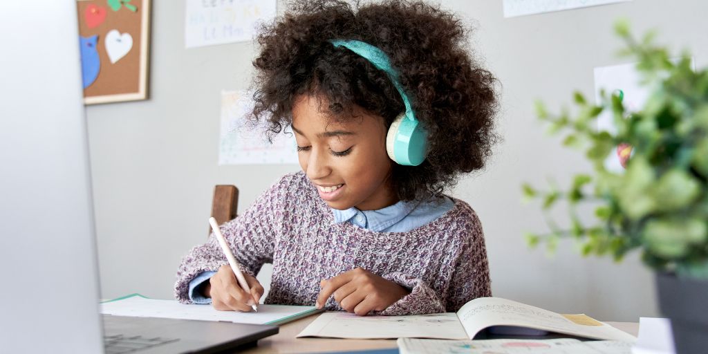 Child doing homework at laptop