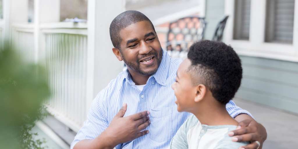 Father and son talking outside