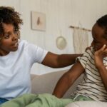 Mother talking to son on couch