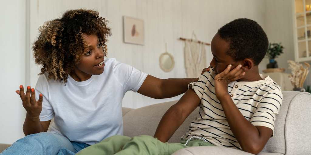 Mother talking to son on couch