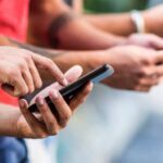 Closeup of hands using phones