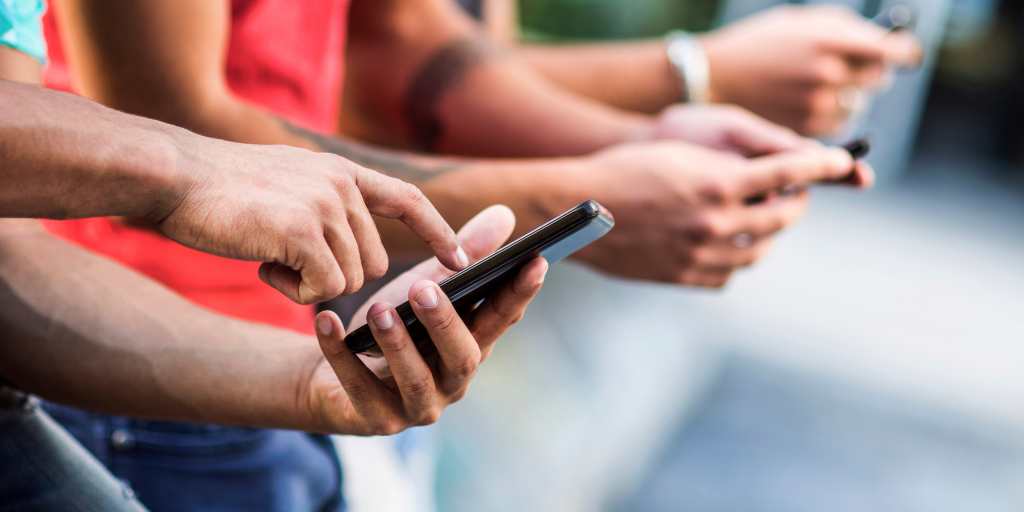 Closeup of hands using phones