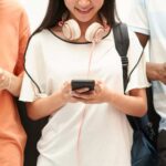 Three kids using smartphones