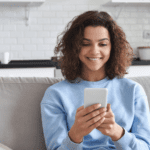 Teen using phone on couch