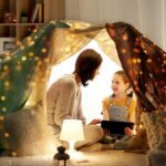 Mother and daughter under tent