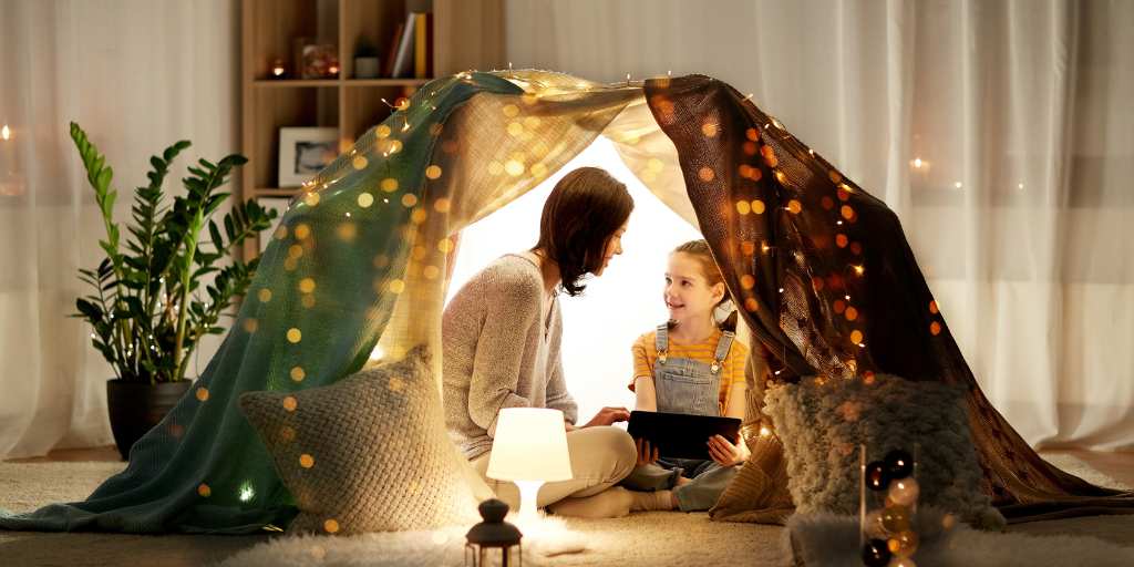 Mother and daughter under tent