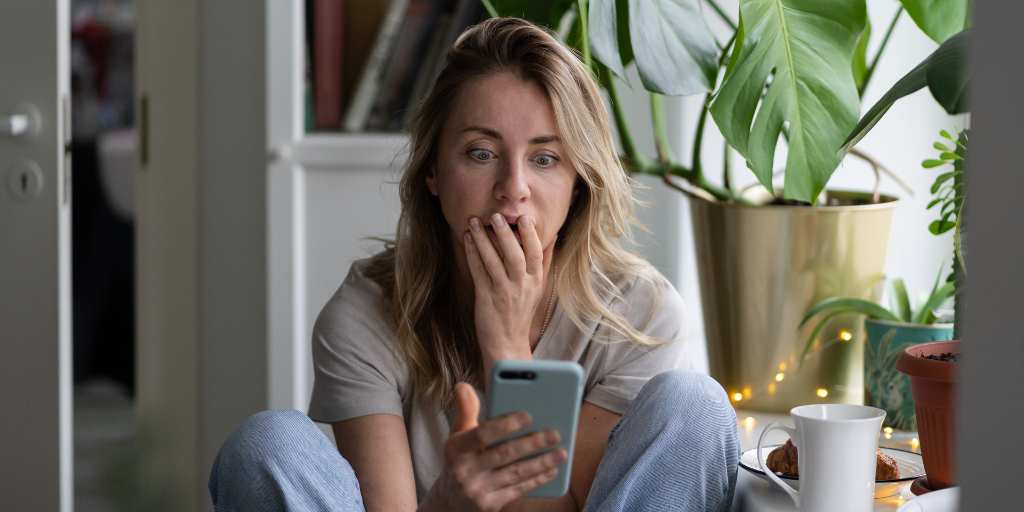 shocked mother looking at phone