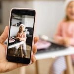 Parent taking a photo of child