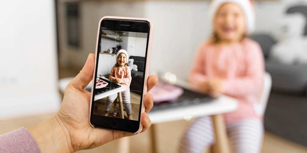 Parent taking a photo of child