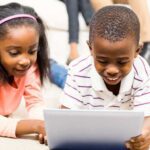 Two children using iPad for kids