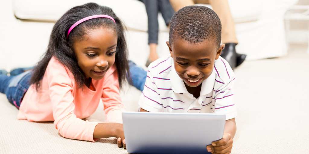 Two children using iPad for kids