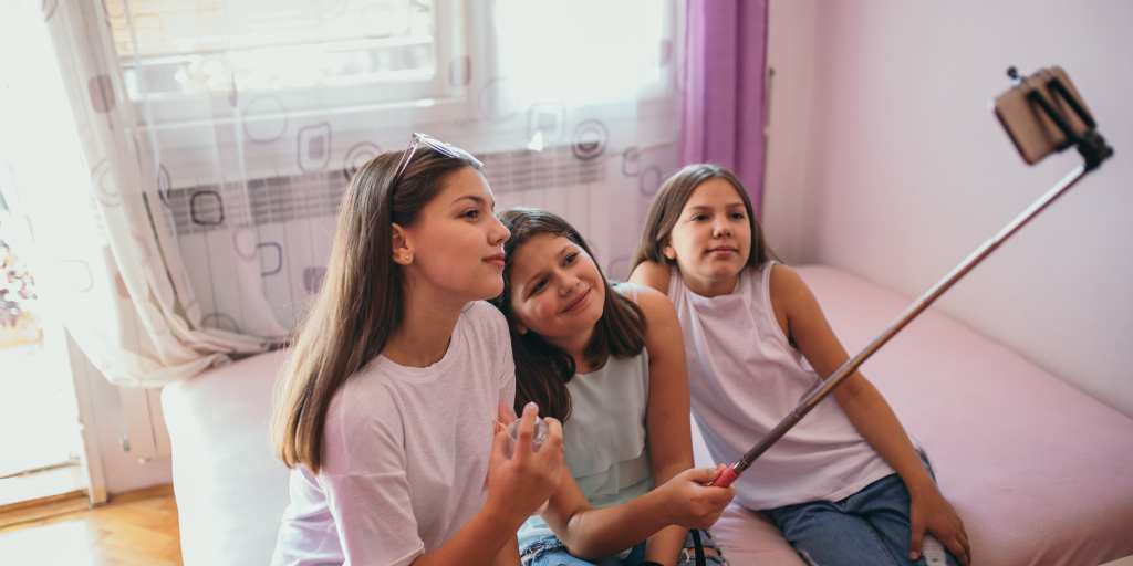 Girls taking selfie with selfie stick