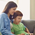 Mother and son looking at laptop