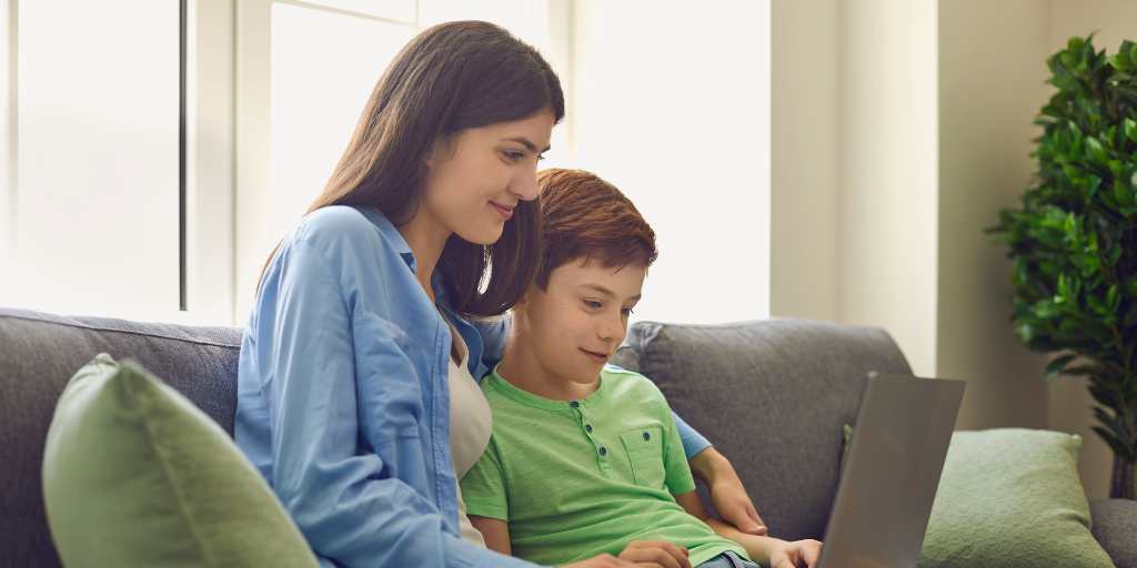 Mother and son looking at laptop