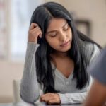 Teen looking down at desk