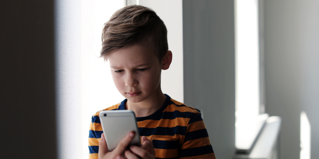 worried child looking at phone