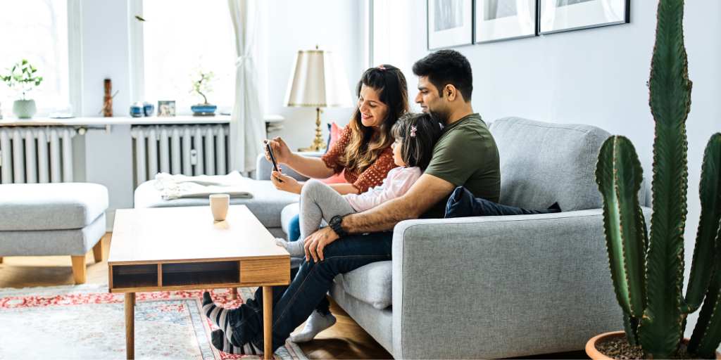 Family taking selfie on couch