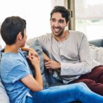 Father and son talking on couch