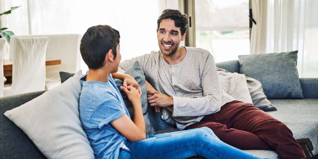 Father and son talking on couch