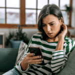 Mom looking at phone on couch