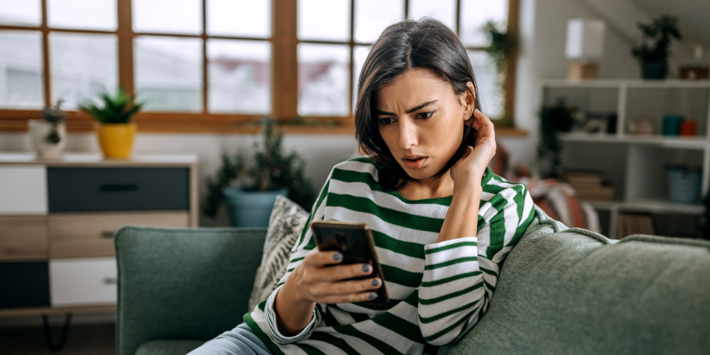 Mom looking at phone on couch