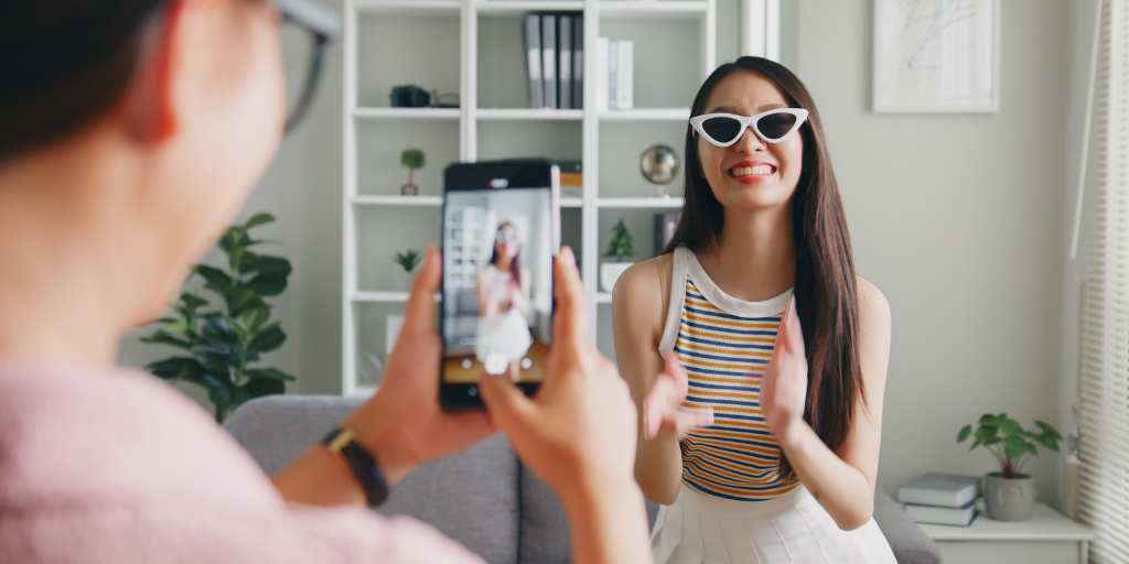 Friend recording a girl on smartphone