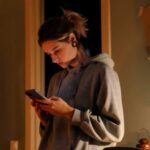 Teen girl texting in bedroom