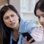 Mother looking at child on phone