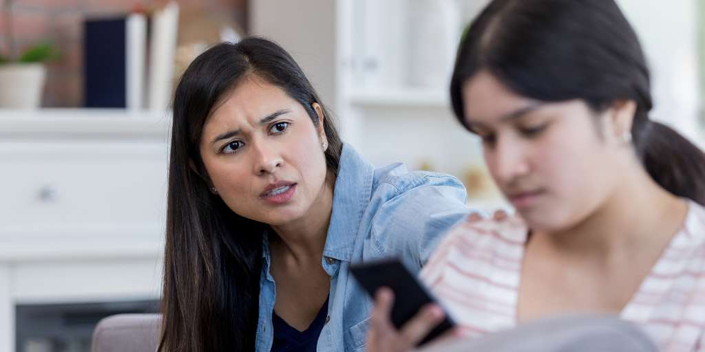 Mother looking at child on phone