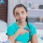 Child rolling her eyes at mom taking phone away