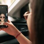 teen girl using instagram to take selfie in car