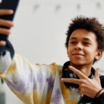 teen boy taking selfie with smartphone