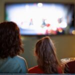 Parent watching movies with teens