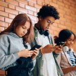 Teens looking at phones in school