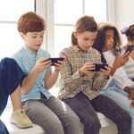 group of kids looking at smartphones