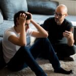 teen and dad having discussion on floor