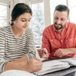 Dad helping daughter with homework