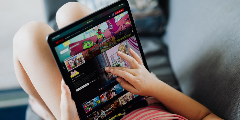 Child watching Netflix on tablet with parental controls