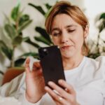 Woman using AI assisted parenting tools on iPhone