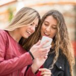 Two girls looking at TikTok alternatives