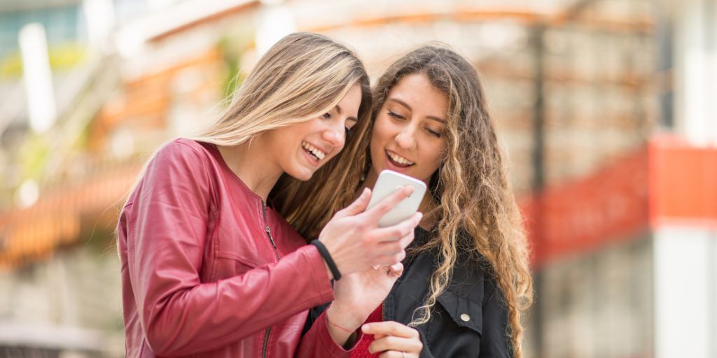 Two girls looking at TikTok alternatives