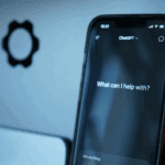 Phone with ChatGPT in front of laptop