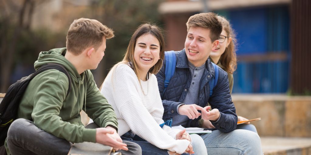 Group of teens talking together without phones