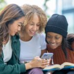 group of girls using AI app on phone