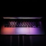 Slightly open laptop on black background